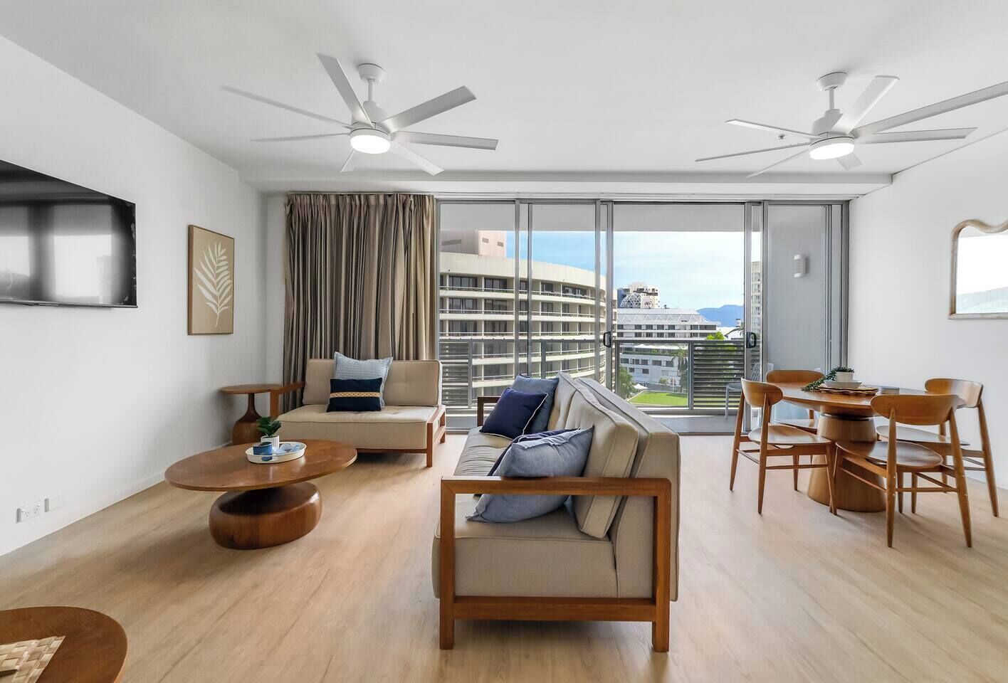Full-height glass doors fill the lounge with natural light and open to sweeping views, creating an inviting indoor-outdoor flow perfect for unwinding after a day by the water.