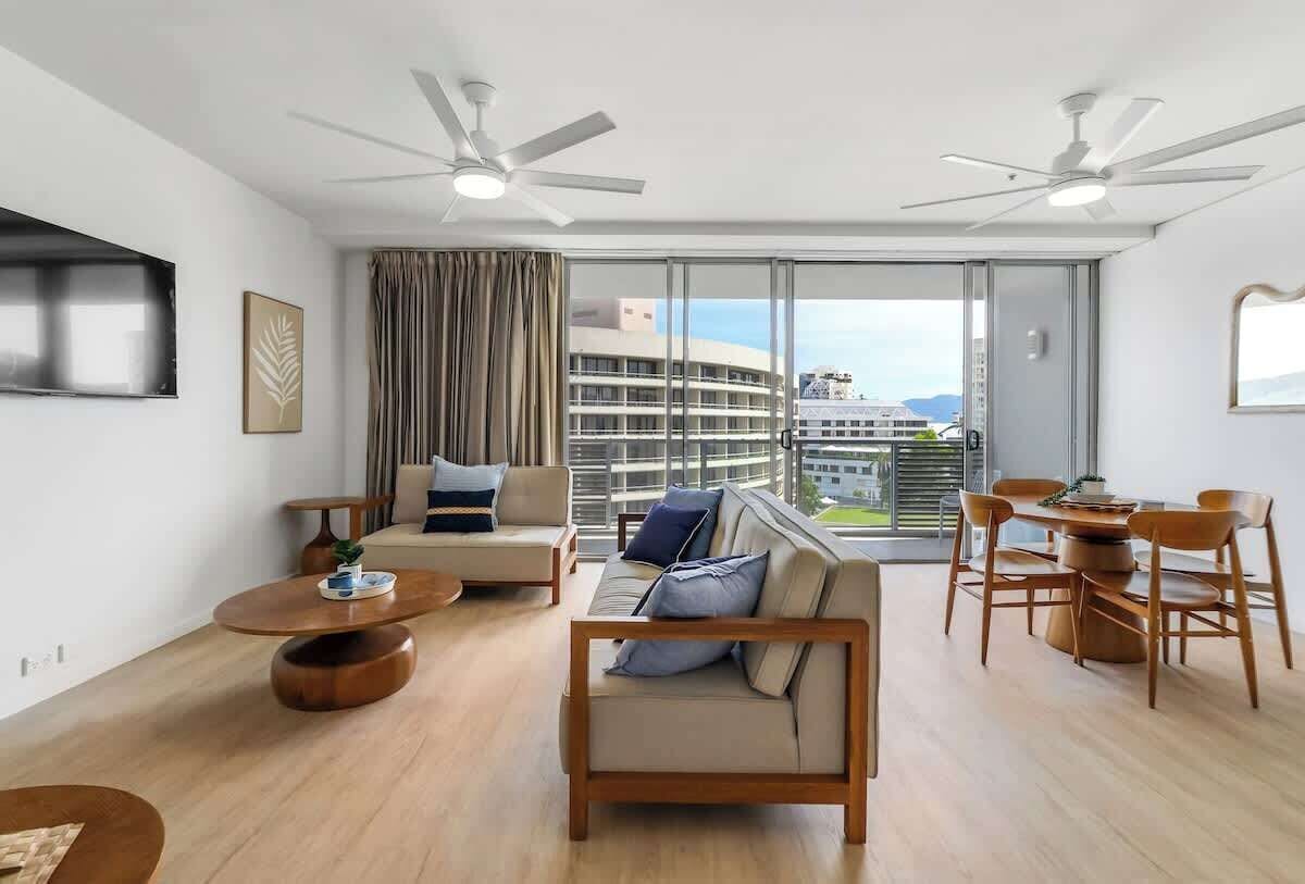 Full-height glass doors fill the lounge with natural light and open to sweeping views, creating an inviting indoor-outdoor flow perfect for unwinding after a day by the water.