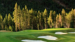 A golf course with sand bunkers and a forested backdrop. - The Keep | Ski-In/Out Toby Chair | Ground Floor (Panorama)