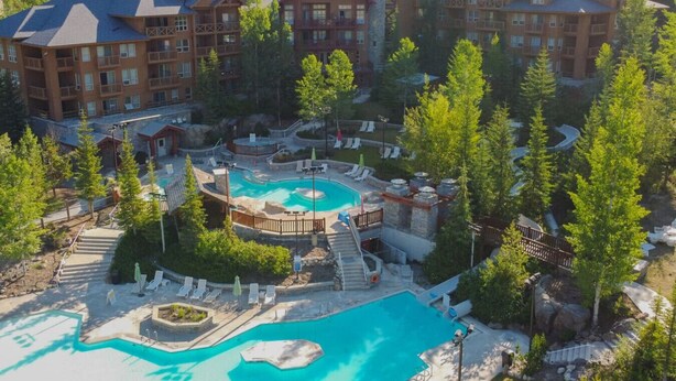 A resort with multiple buildings, a central pool area, and surrounding greenery. - The Keep | Ski-In/Out Toby Chair | Ground Floor (Panorama)