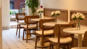 A restaurant interior with wooden furniture, a modern light fixture, and a view of the street outside. - alaturka mansion (İstanbul)