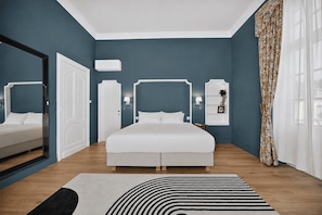A modern bedroom with a large bed, a mirror, a wardrobe, and a bedside table with a lamp. - Villa Damseaux (Spa)