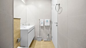 A modern bathroom with a shower, toilet, and sink. - 106 Bloomfields Executive STU Gate Masdr (Madinat Zayed)