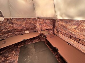 A tented room with two tables, a small table, and a Coleman cooler. - Camo Dome Tent (Lincoln)