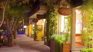 A nighttime street view with storefronts, including 'Gilles of Carmel' and 'Evan Gallery'. - Monterey Bay Escape (Seaside)