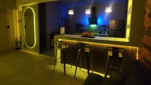 Une cuisine moderne dotée d’un îlot central, de tabourets de bar et de luminaires suspendus.