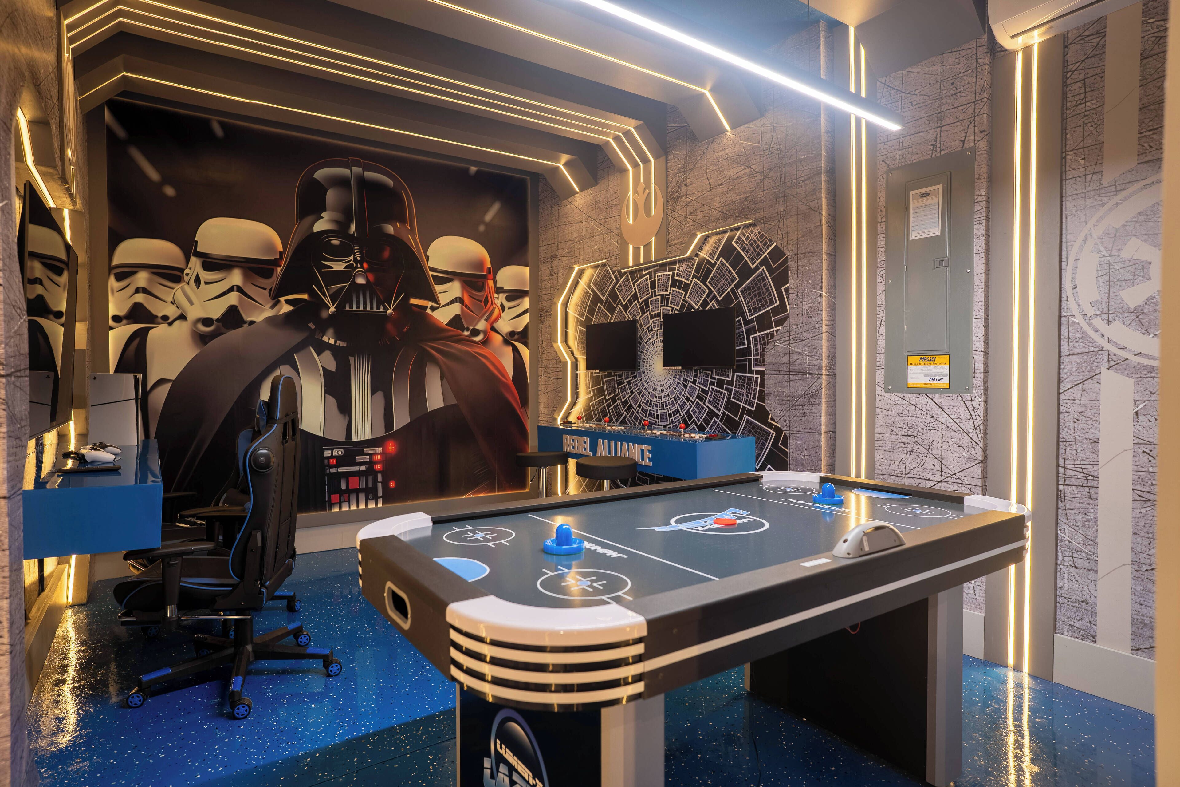 Une table de billard décorée sur le thème de Star Wars, avec des figurines de stormtroopers et un portrait de Dark Vador.