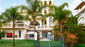 A two-story building with balconies, a gated entrance, and lush greenery. - 4 bedroom amazing apartment in Ferruzzano (Ferruzzano)