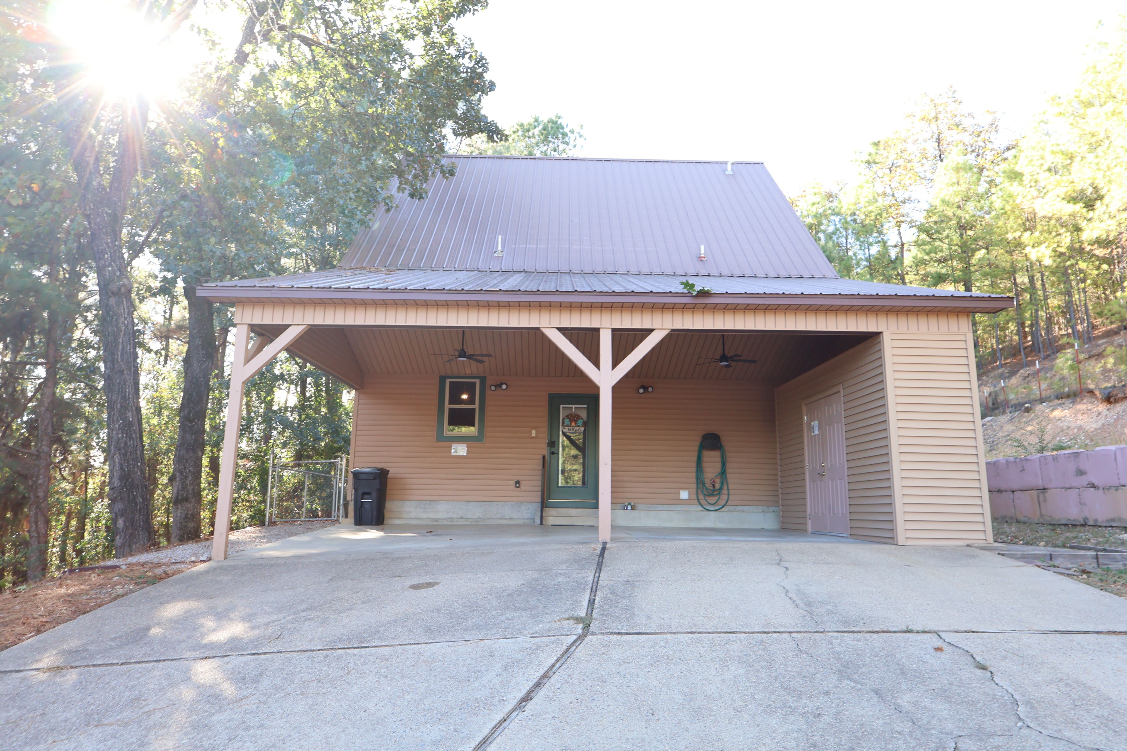 A building with a covered porch, a door, and a window.