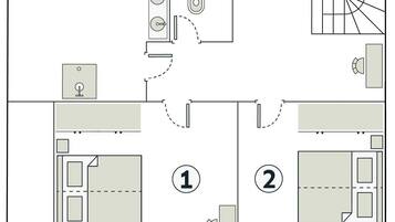 Plano de planta de un hotel con dos dormitorios, un baño, una cocina y un comedor.