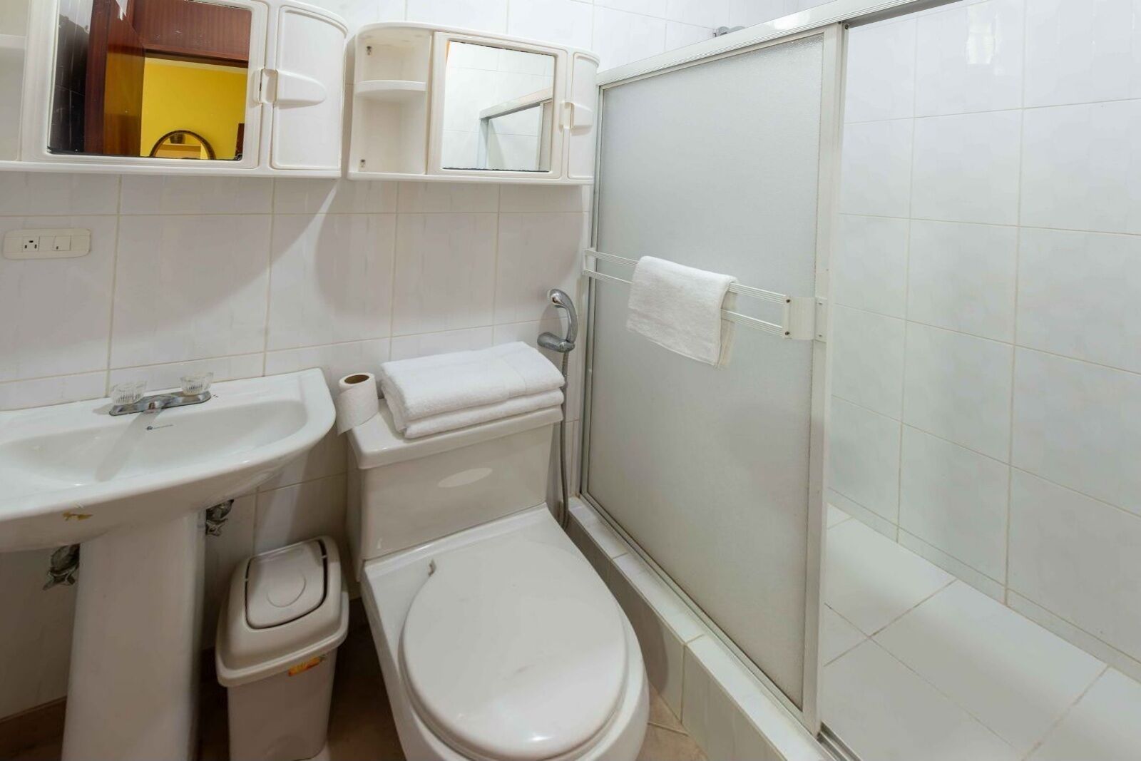 A bathroom with a sink, toilet, and shower.