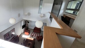 A multi-level interior with a dining area, red sofas, and hanging paper lanterns. - Splendid house, very bright, 3 bedrooms, 3 bathrooms, kitchen, barbecue. Courtyard (Chascomús)