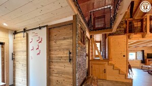 A wooden interior with a stone wall, a staircase, and a bench. - La Liete - 1st Floor (BESSANS)
