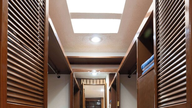 A corridor with wooden lockers, a tiled floor, and a skylight. - Family Home with Heated Pool (Guadalajara)