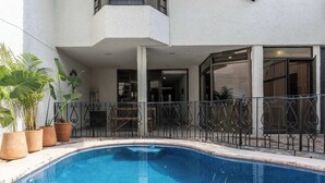 A two-story house with a swimming pool, a balcony, and potted plants. - Family Home with Heated Pool (Guadalajara)