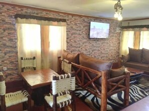 Family Chalet, Garden View | Living area | 32-inch Smart TV with digital channels - Wooden Knee cottages Nanyuki (Nanyuki)