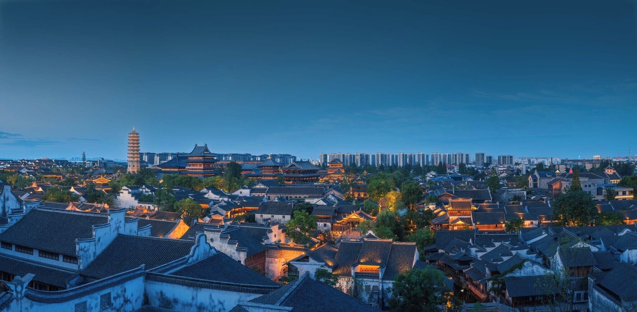 A traditional Chinese cityscape with historic buildings and a pagoda.