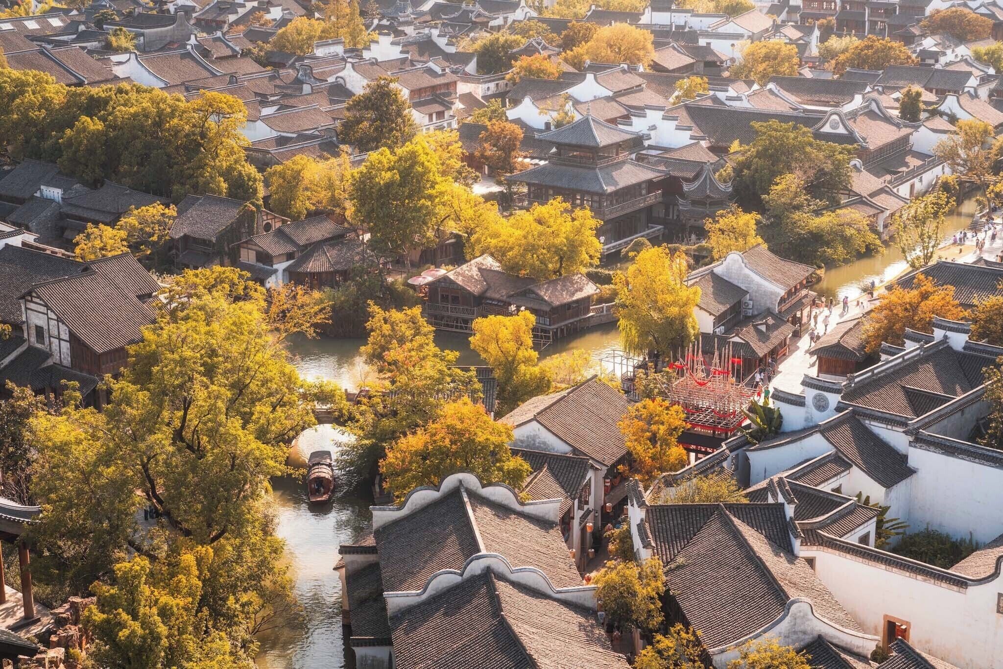 A traditional village with narrow streets and buildings with tiled roofs.