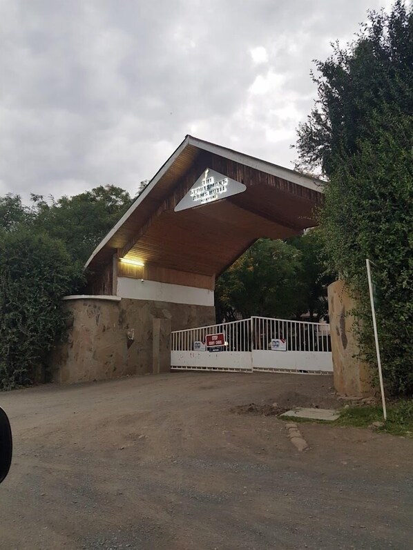 A building with a sign reading "The St. Thomas Arms Hotel." - The Sportmans Arms Hotel (Nanyuki)