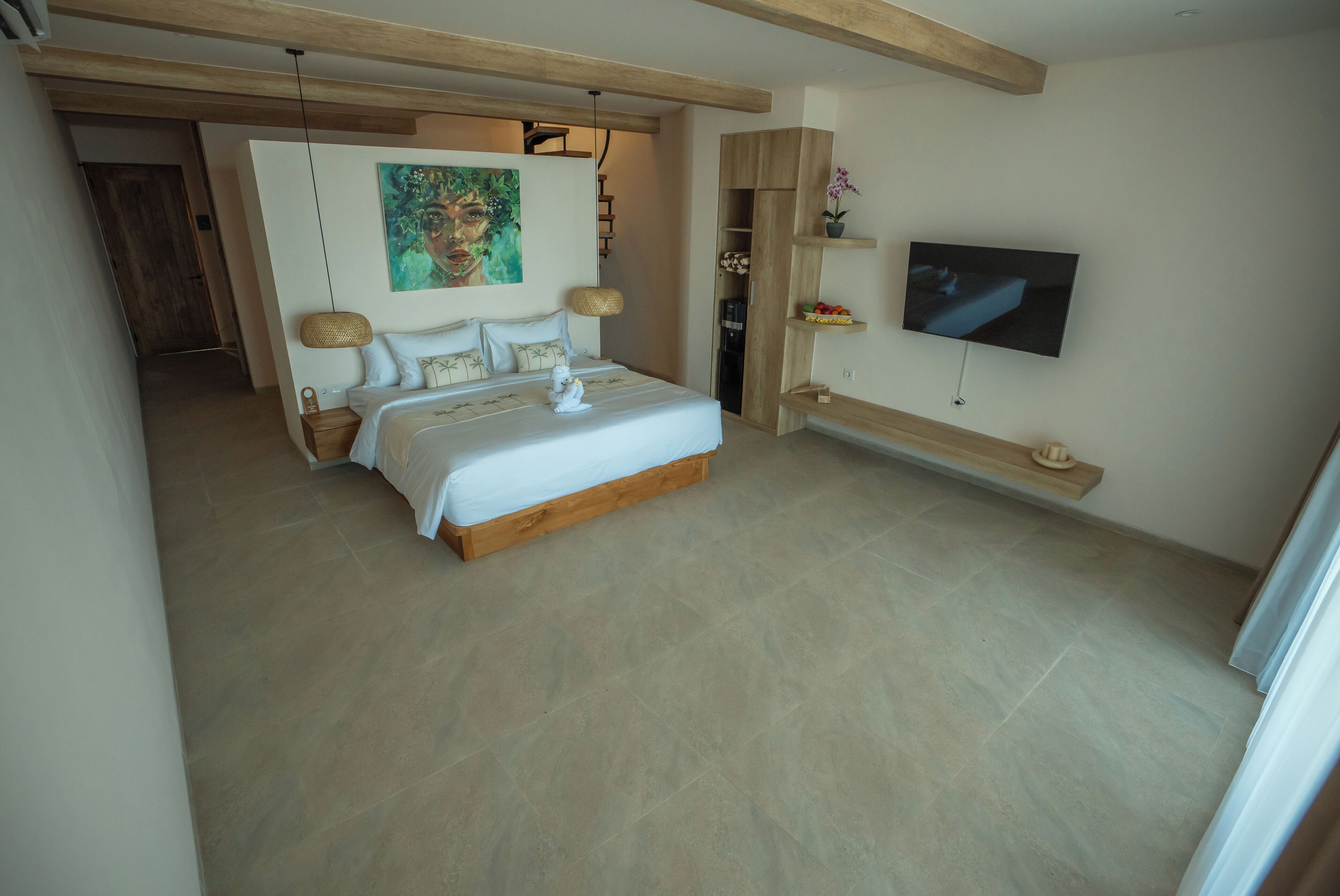 A modern bedroom with a large bed, a TV mounted on the wall, and a wooden ceiling.