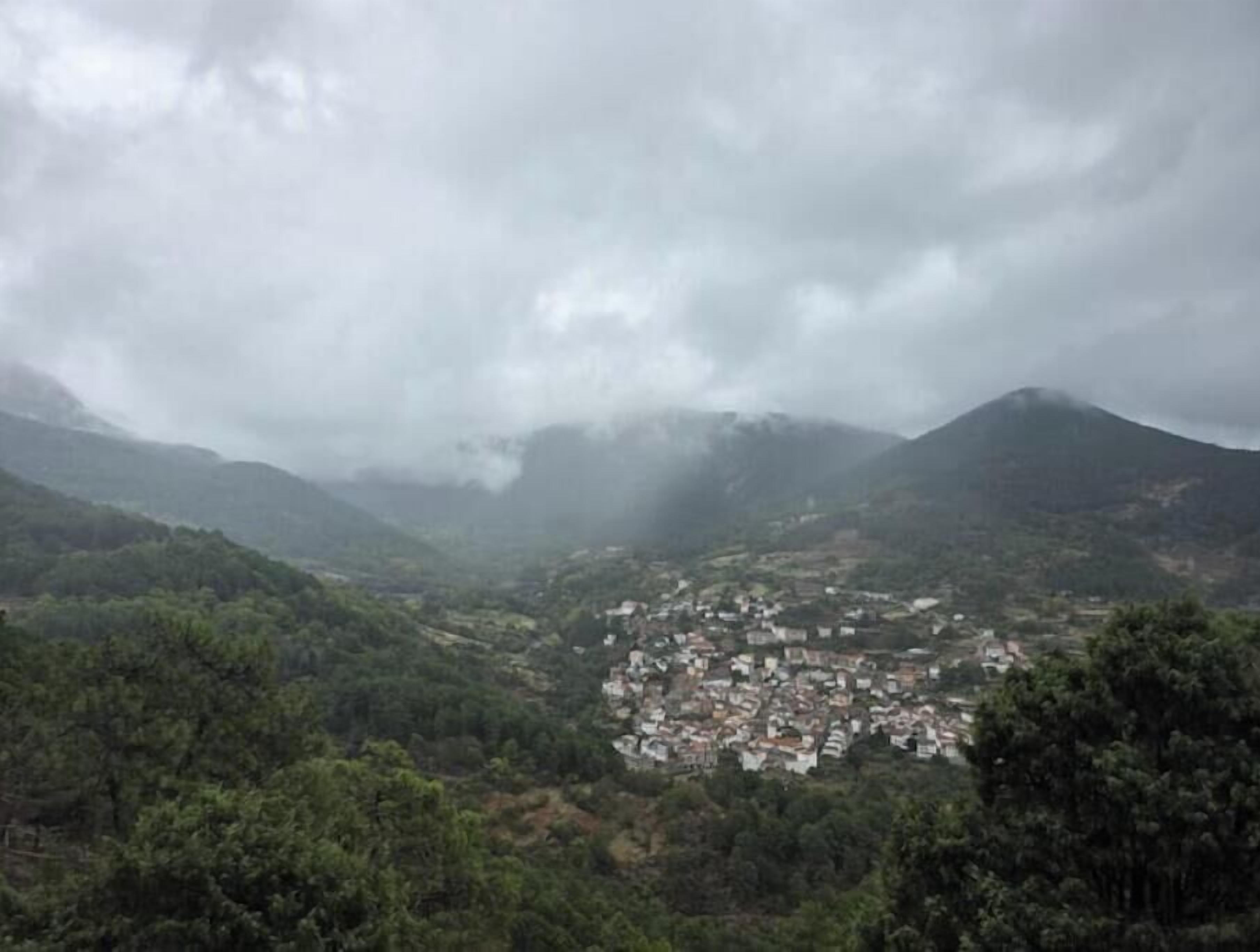 A mountainous landscape with a town nestled in a valley.