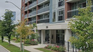A multi-story building with a modern design, featuring balconies on each floor.