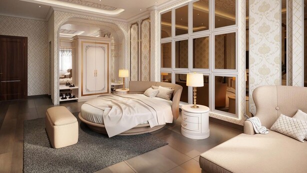 A luxurious bedroom with a large bed, a sitting area, and a wardrobe. - Heaven Hotel (Vu Ninh)