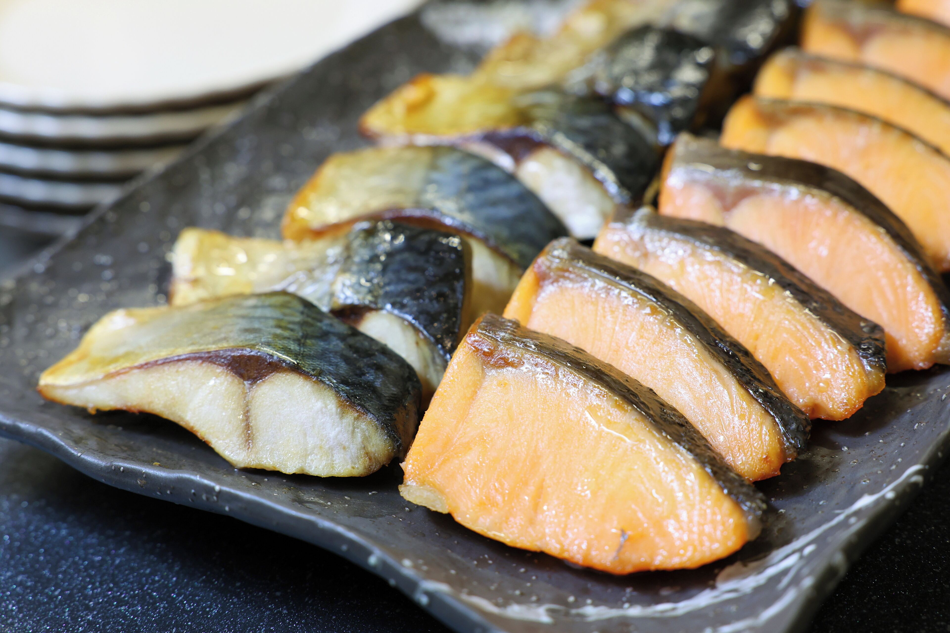 A plate of sashimi with various fish slices.