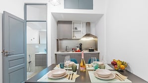 A modern kitchen with grey cabinets, a built-in oven, and a stainless steel range hood. - Saro House, Centre Apartment for 6, Sanremo, Italy (Sanremo)