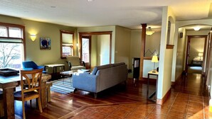 A spacious living area with a sofa, dining table, and chairs. - Habart Retreat - Country Living at its Best (Golden)