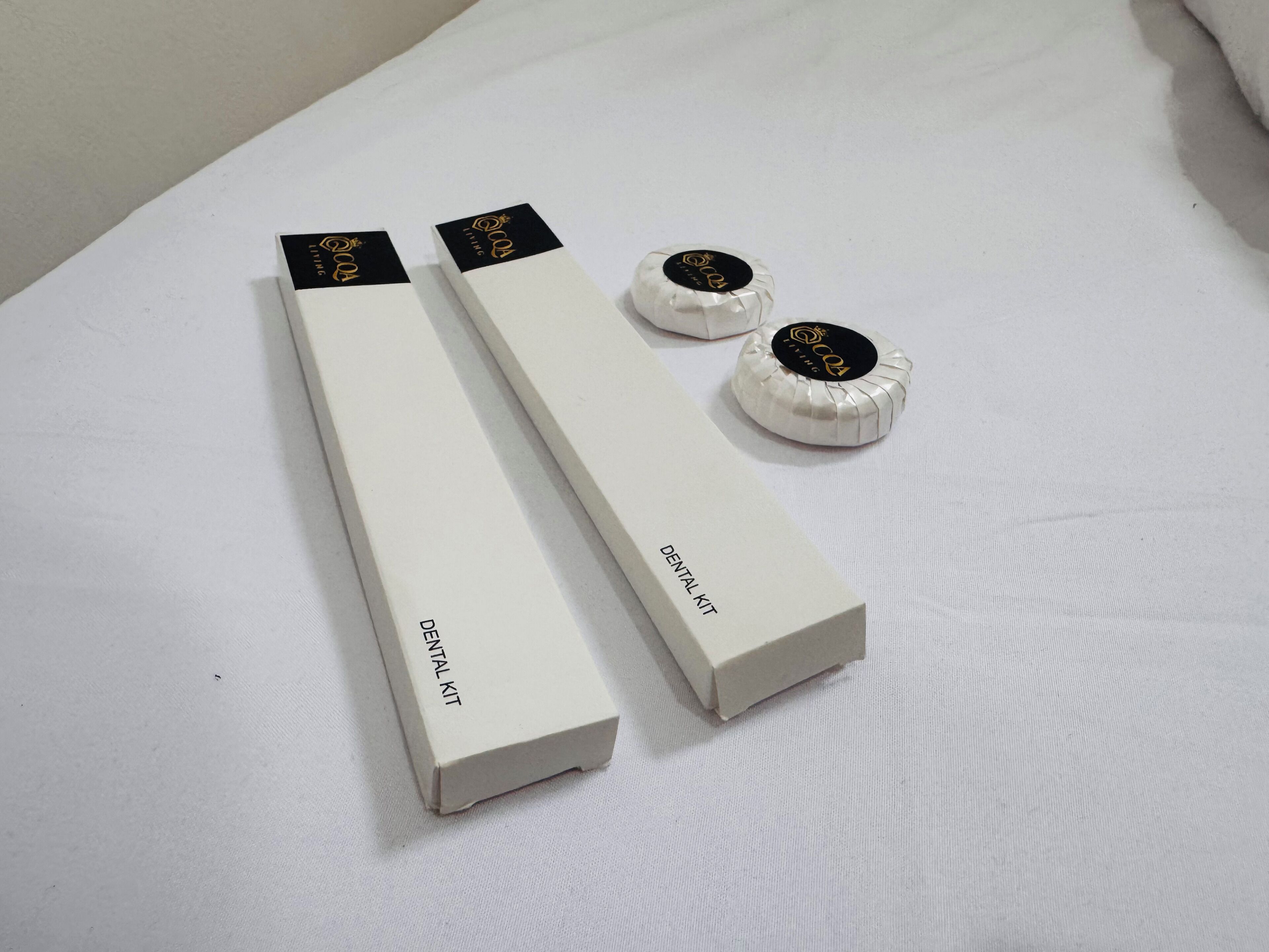 A dental kit and two dental floss containers on a white surface.
