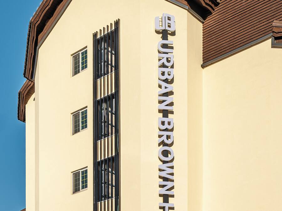 A building with a sign reading "BURBAN BROWN HOTEL".