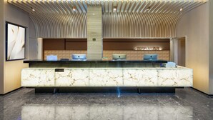A hotel reception desk with a marble counter, multiple laptops, and a sign reading "Premier Club". - Echarm PLUS Hotel Chongqing  (Chongqing)