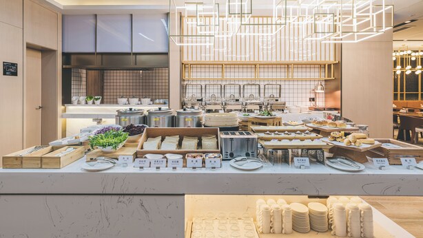 A modern kitchen with a variety of food items and utensils displayed on the counter. - Echarm PLUS Hotel Chongqing  (Chongqing)