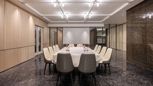 A conference room with a long table, chairs, a projector screen, and a whiteboard. - Wanda Yue Xi'an High-tech Zone (Xi'an)