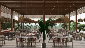 A spacious outdoor dining area with multiple tables and chairs, a central potted plant, and a wooden ceiling structure. - Solivia Hotel (Konaklı)