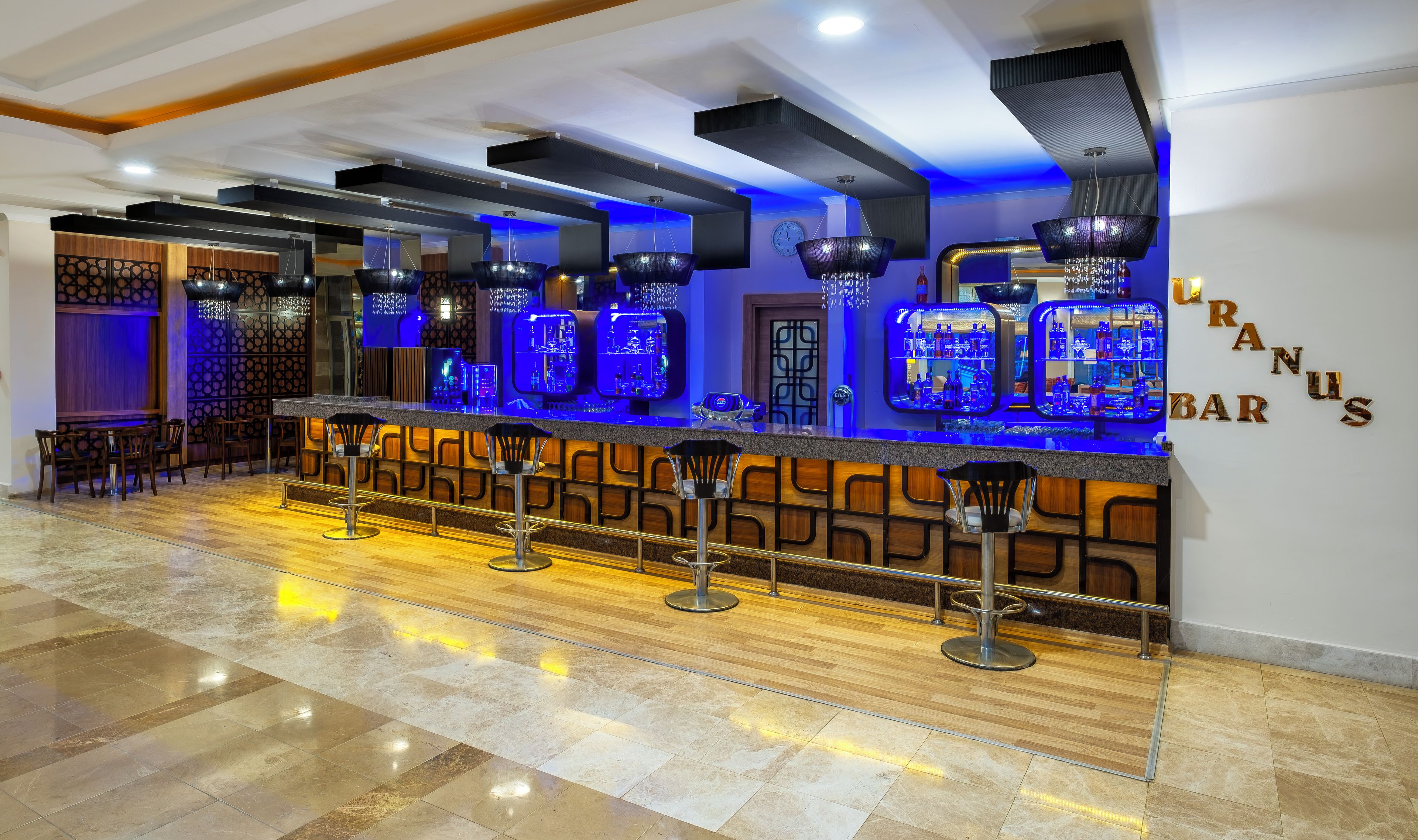 A bar area with a counter, stools, and a sign that reads 'GRANUS BAR'.