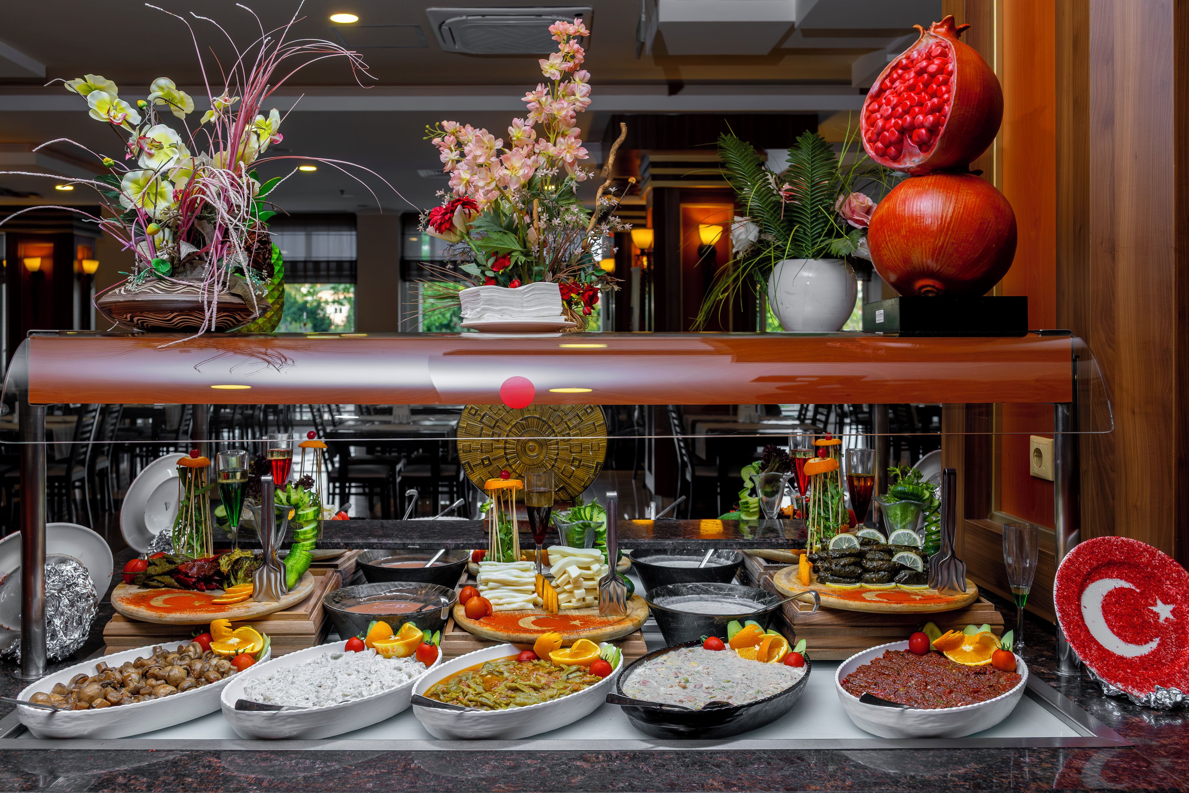 A buffet with various dishes and a potted plant.
