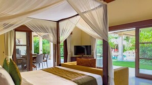 A room with a bed, a TV, and a view of the outdoors. - Spacious 4BR - Villa Santai - Central Seminyak (Badung)