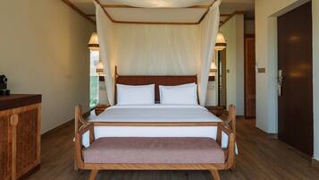 A bed with a canopy, wooden headboard, and bedside tables with lamps.