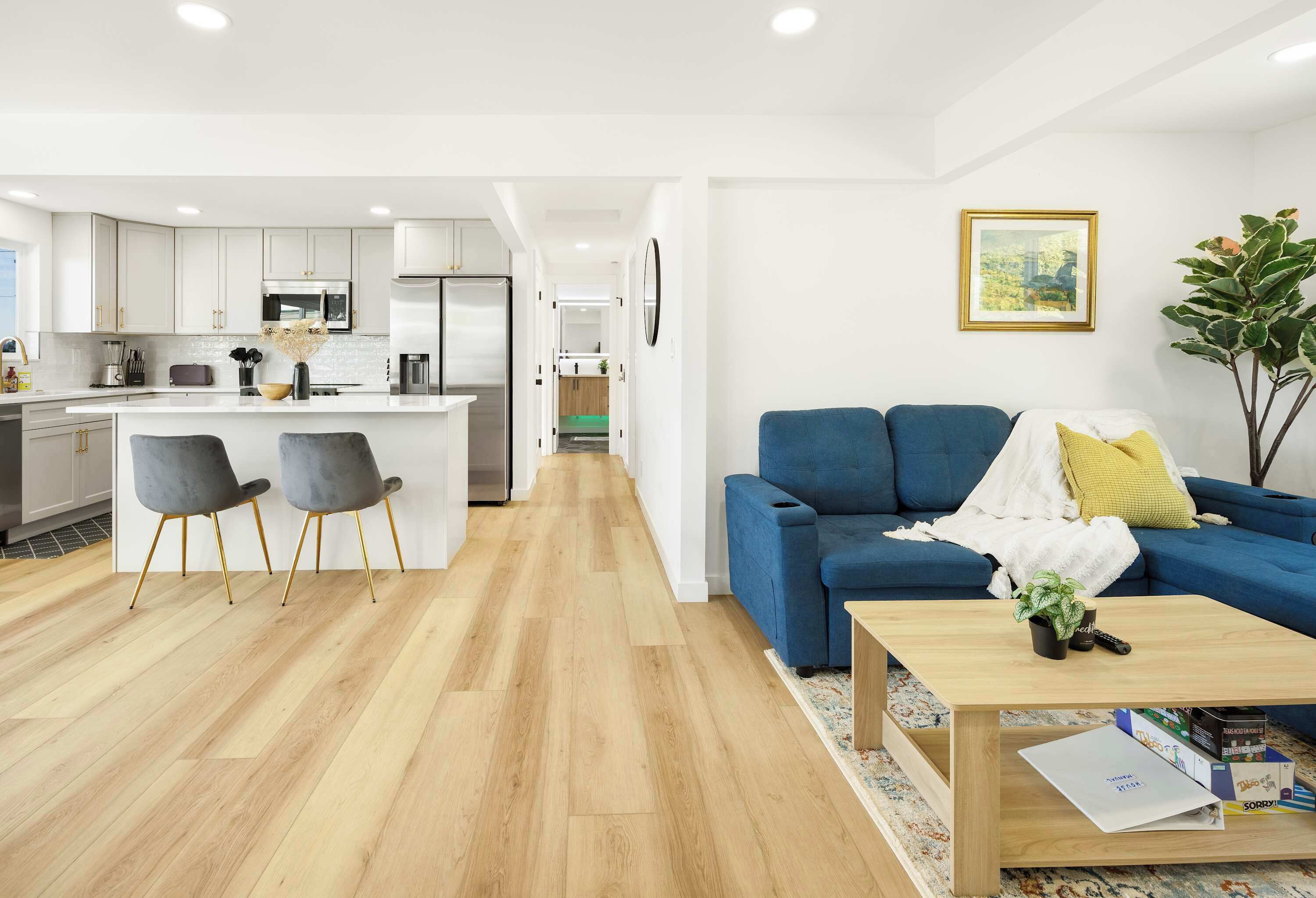A modern apartment with a kitchen, dining area, and living room.