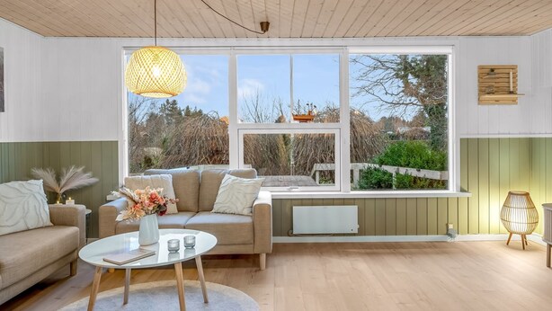A modern living room with a sofa, coffee table, and a large window with a view of the outdoors. - "Felicia" -  from the sea by Interhome (Hals)