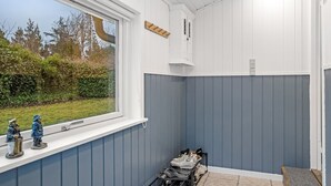 A small, enclosed room with a window, a shoe rack, and a small cabinet. - "Felicia" -  from the sea by Interhome (Hals)