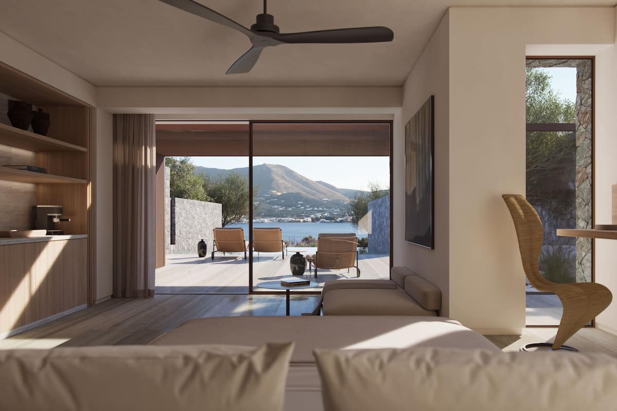 A modern bedroom with a large sliding glass door leading to a balcony with a view of a mountain and sea.