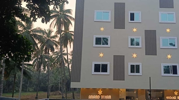A hotel with multiple windows, a signboard, and a logo. - Anand Vihar Hotel (Ambajipeta)