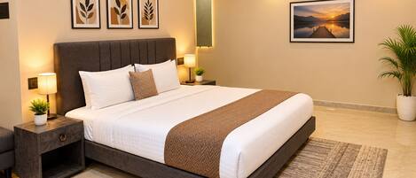 A neatly made bed with a brown and white striped blanket, two bedside lamps, a nightstand with a plant, and a framed picture on the wall.