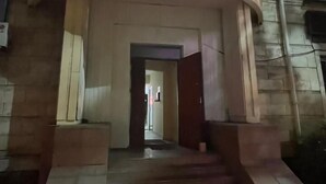 The entrance to Naya Hotel with a prominent illuminated sign, a set of stairs leading up to the entrance, and a pathway in front. - Naya Hotel (Almaty)