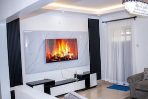 Family Bungalow, Garden View | Living area | 32-inch Smart TV with digital channels