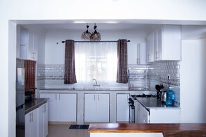 Family Bungalow, Garden View | Private kitchen | Fridge, microwave, cookware/dishes/utensils