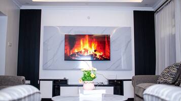 Family Bungalow, Garden View | Living area | 32-inch Smart TV with digital channels